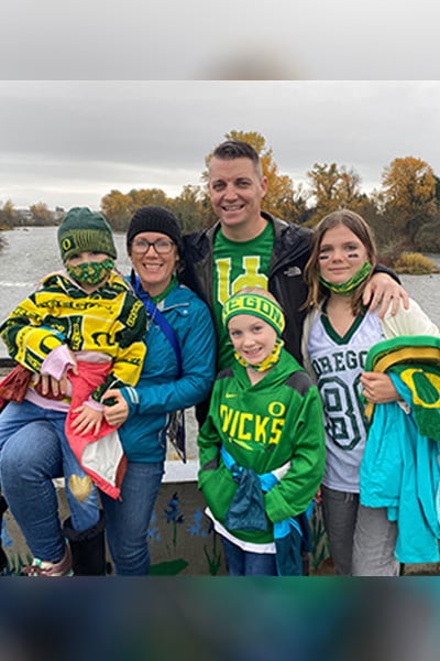 The Malone family on the Autzen footbridge before a Ducks game
