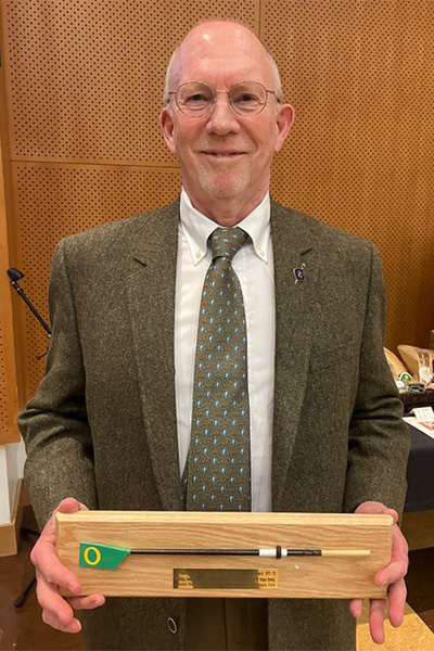 Don Costello with a commemorative oar plaque