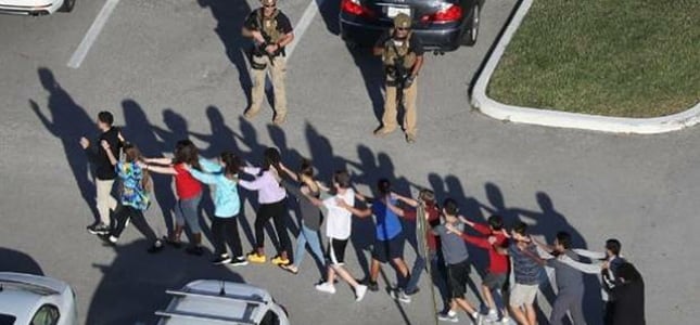 students being led out of school following a shooting