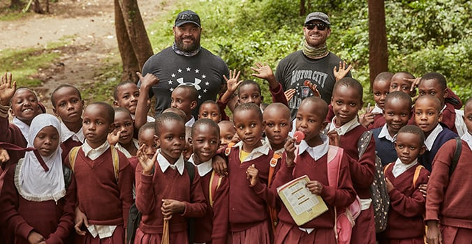 Haloti Ngata and Chris Long with schoolchildren in Tanzania