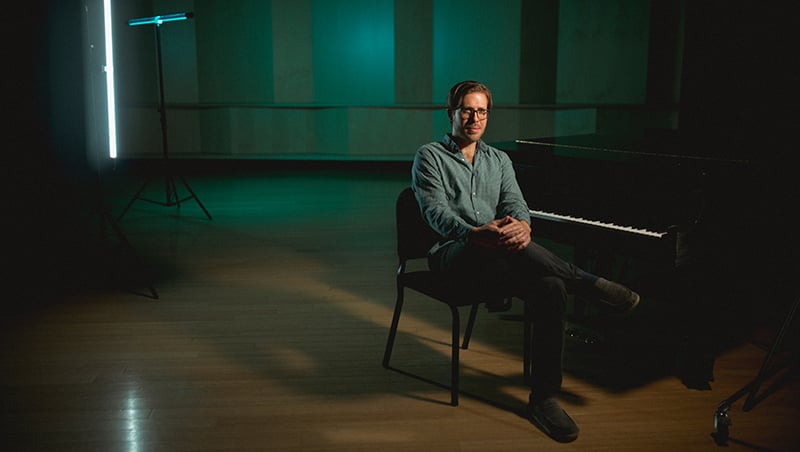 Chris Thomas seated at a piano