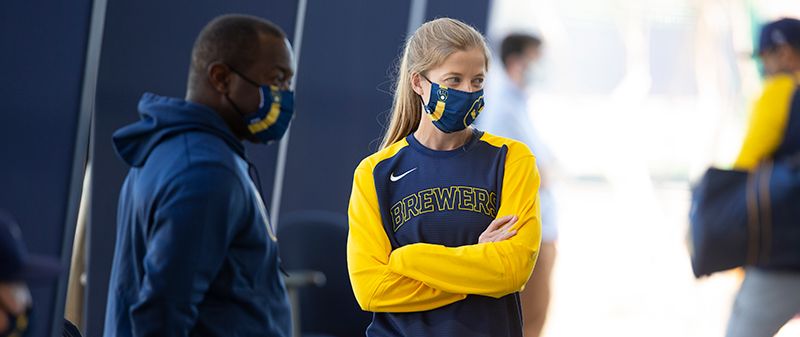 Sara Goodrum talks to a Brewers coach during spring training