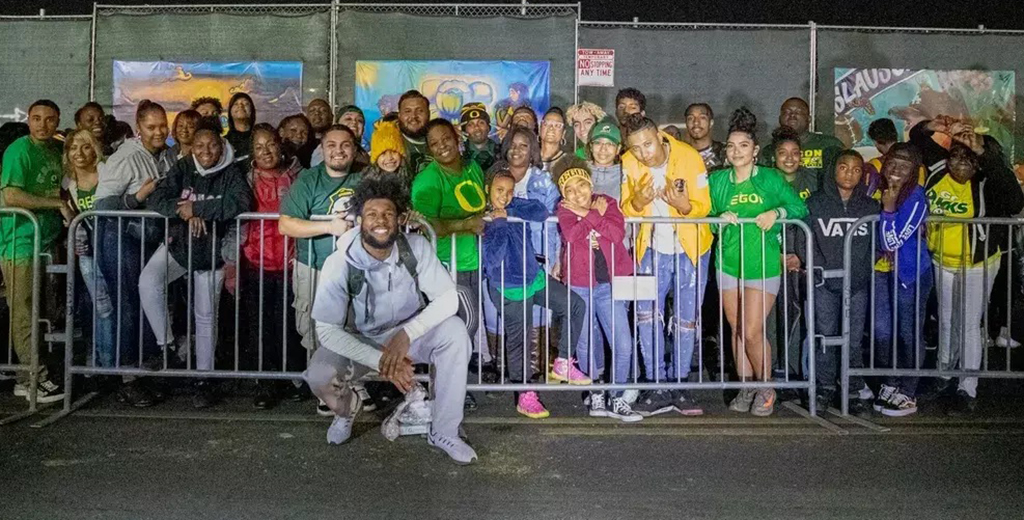 Kayvon with kids and fans at an event