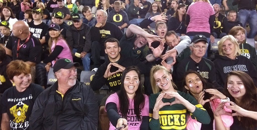 Yusuf and Tal at an Oregon football game with fellow Ducks fans