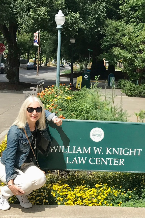 Diane Polscer beside the Knight Law Center sign