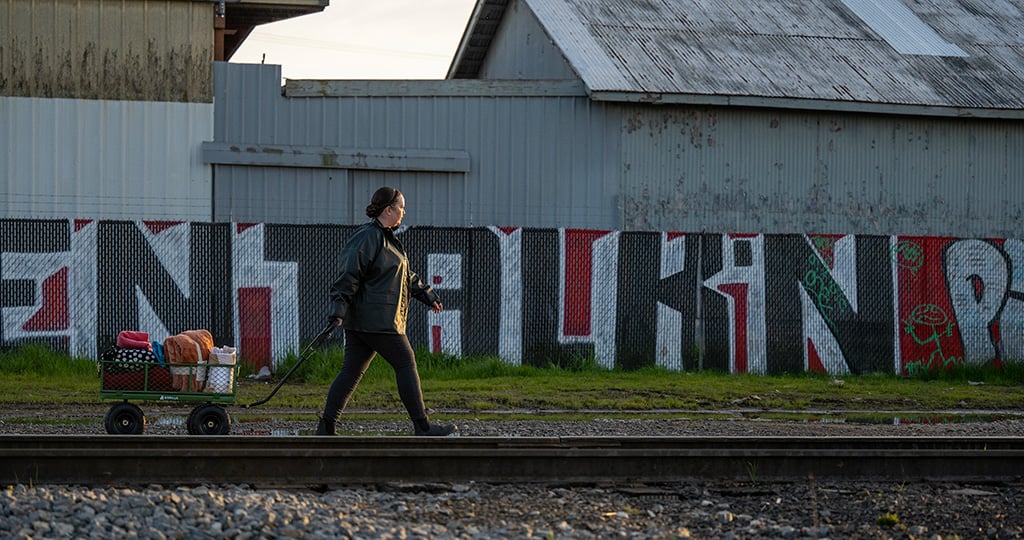 Sarah Koski hauls supplies along train tracks