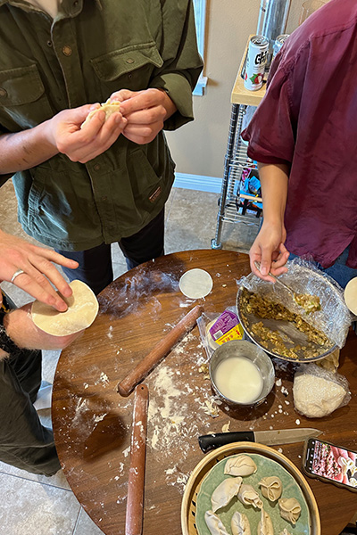 May Wu making dumplings with friends