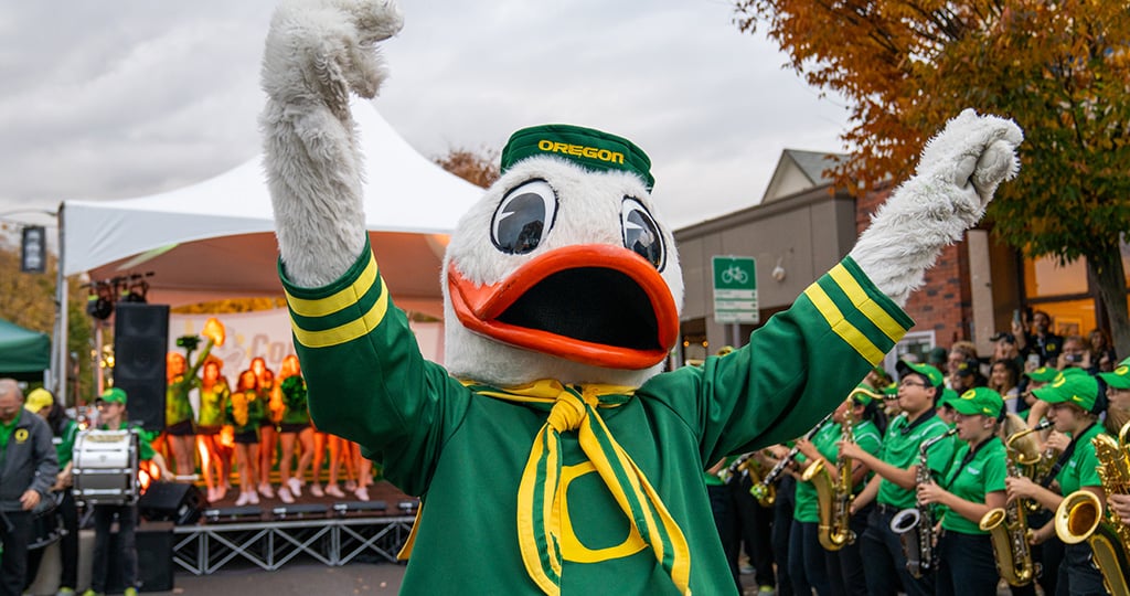 The Duck in front of the Oregon Band and Cheer