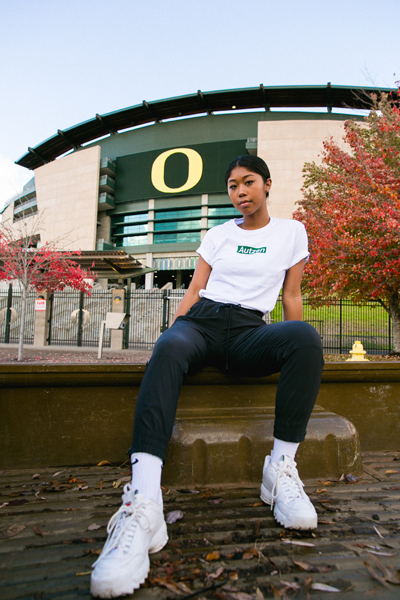 This is the original BoxenAutzen tee modeled after the ‘Supreme’ logo, with UO’s signature green instead of red. Girl in BoxenAutzen shirt in front of Autzen Stadium