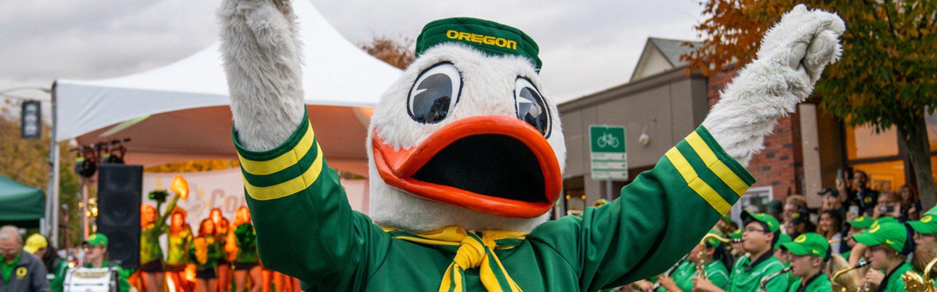 Duck mascot with arms raised