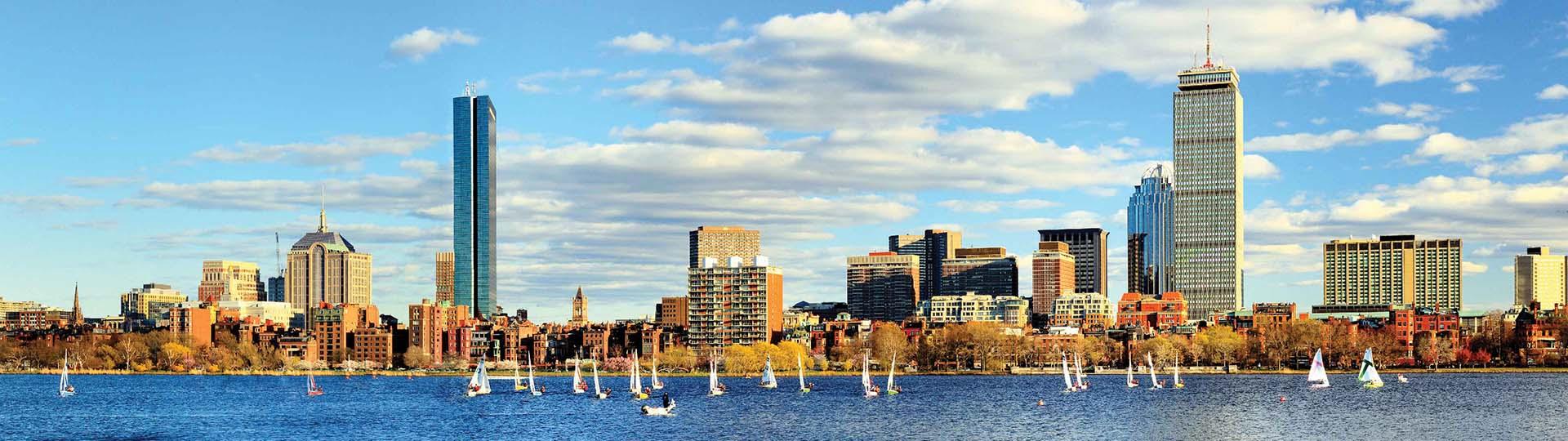 Skyline of Boston in the day behind boats in the water