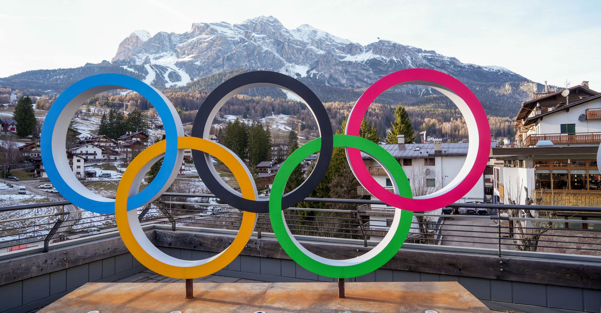 The Olympic Rings on a platform in front of the mountains in Milan, Italy for the 2026 Winter Olympic Games.