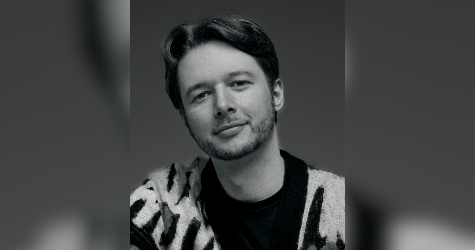 A black and white headshot of a white male