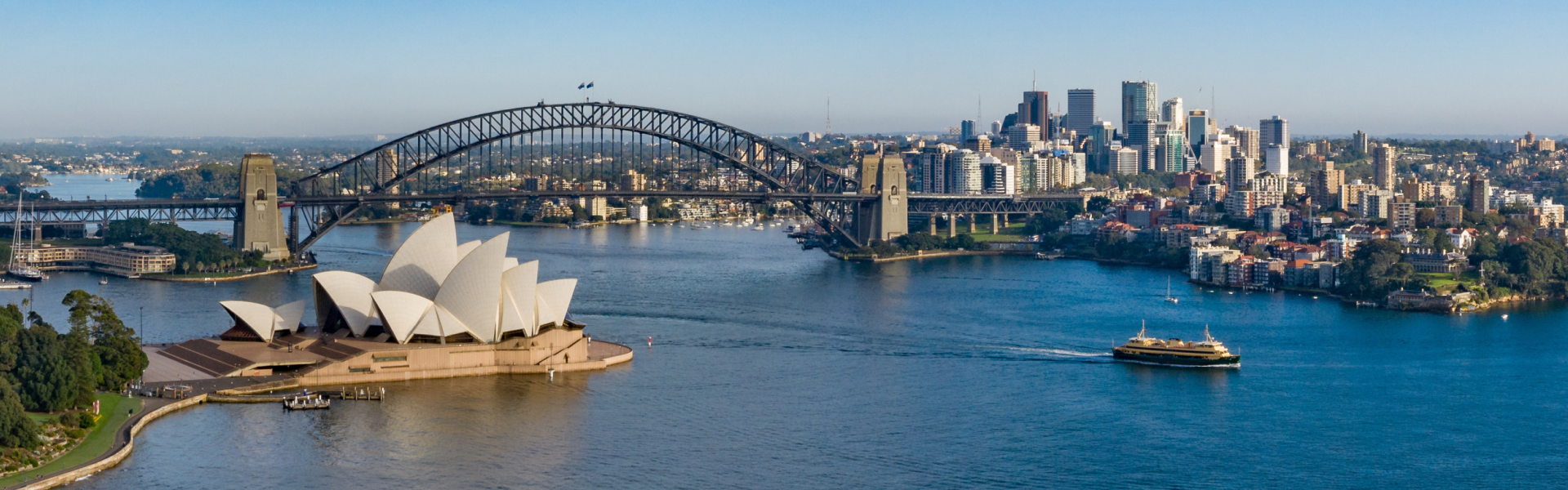 An aerial shot of the Sydney Opera House in Australia and the harbor area.