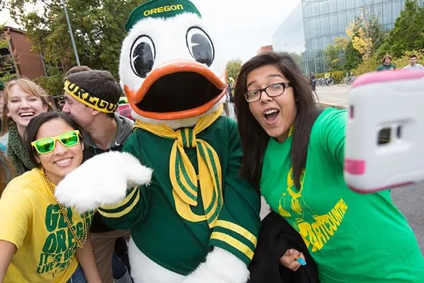 Students pose on campus with The Duck