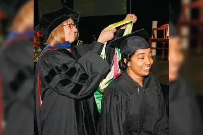 Ammina Kothari getting her graduating ribbon put on her