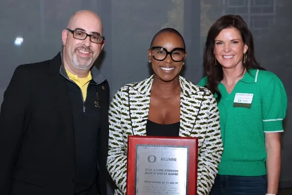 Ericka Warren being presented with the Jeanne Johnson Service award by Raphe Beck and Erin Watkinson