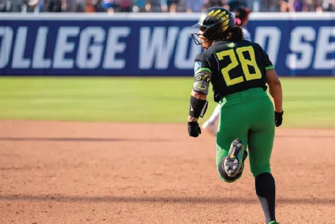 Oregon softball player running to a base