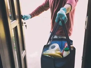 Volunteer delivering groceries