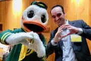 Mascot and Alumn doing the O