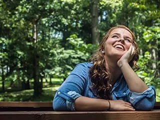 Woman sitting smiling and looking up