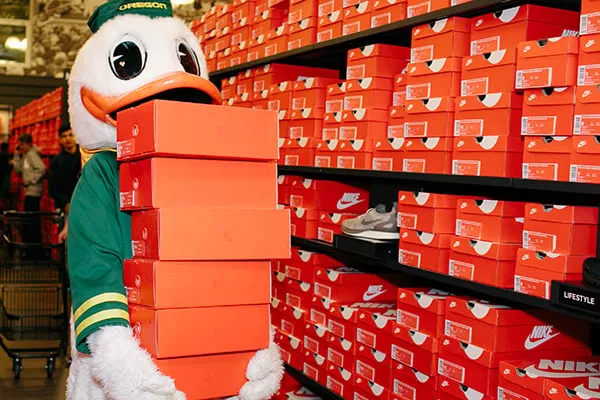 Duck at Nike Store holding stack of Nike shoe boxes