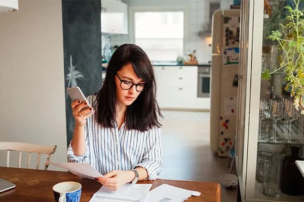 Woman working at kitchen table