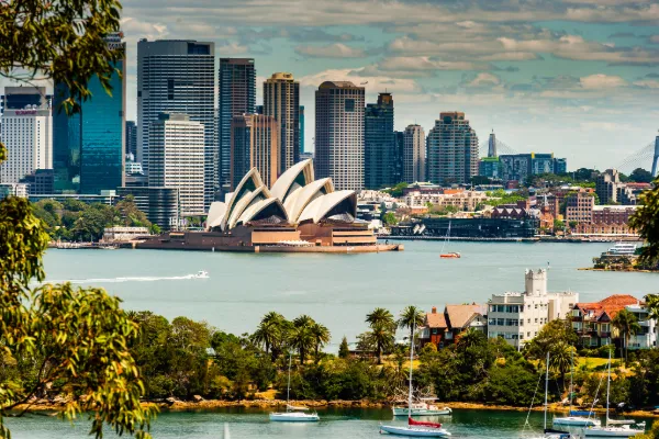 A photo of the Sydney Opera House and Sydney skyline across the harbor.