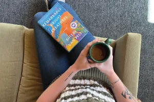 Sitting on the couch with a cup of coffee and book