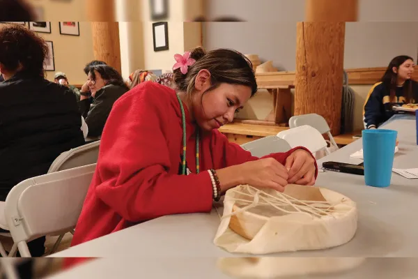 Woman making a traditional Native drum