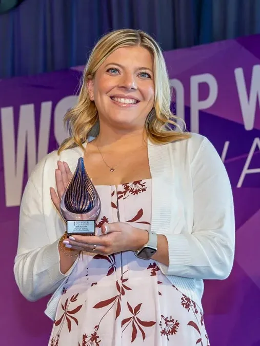 Hannah Oakley holds an award.