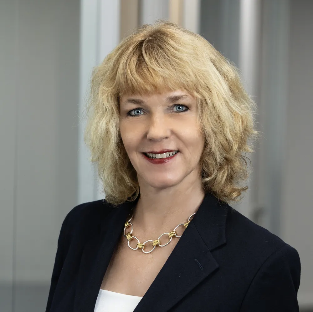 A blonde white woman in a headshot, Myanna Dellinger.