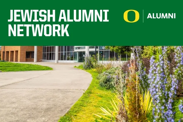 Jewish Alumni Network text on a green banner above a photo of blue flowers next to a sidewalk leading to a building.
