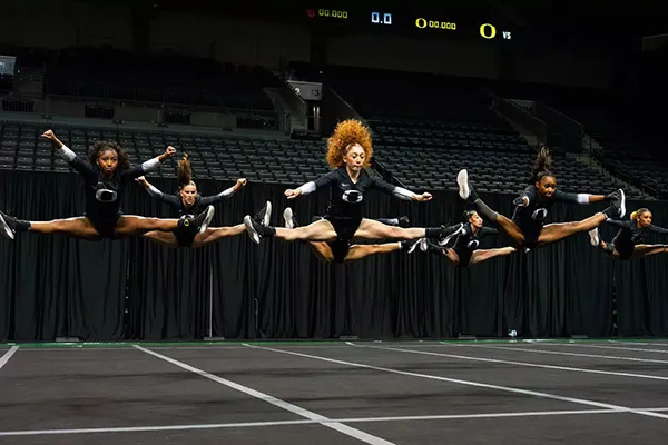 The Oregon acrobatics and tumbling team jumping together in the air