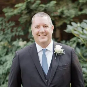 A headshot of Matt Hochstein, a white man in a black suit.