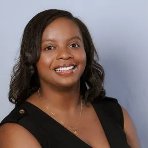 A headshot of Sydnee Walker, a Black woman in a Black blouse.