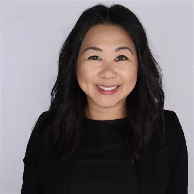 A headshot of Mimi Luong, an Asian woman in a black blouse.