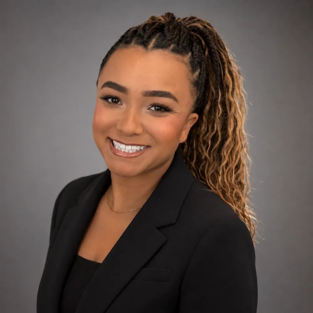 Ashante Jones, a Black woman in a black blazer.