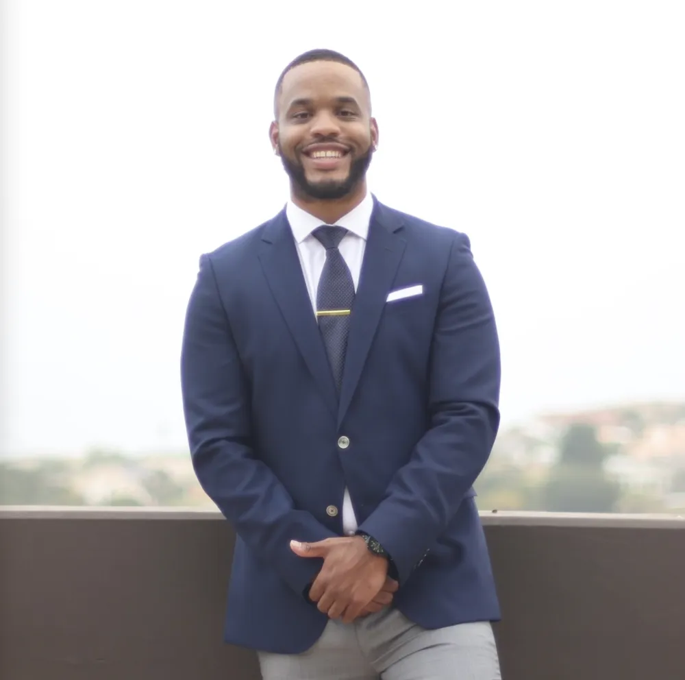 Larryn Zeigler, a Black man in a suit.