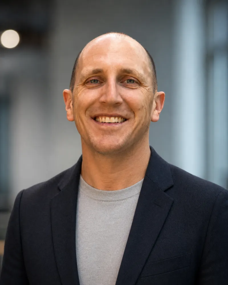 A headshot of Thomas O'Brien, a white man in a blazer.