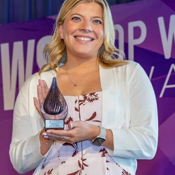 Hannah Oakley holds an award.