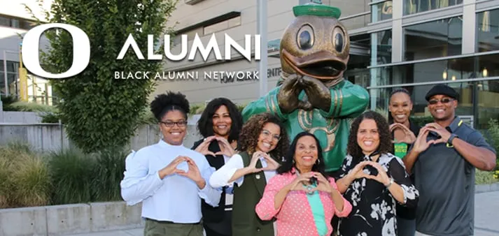 Members of University of Oregon Black Alumni Network in front of statue of Duck Mascot