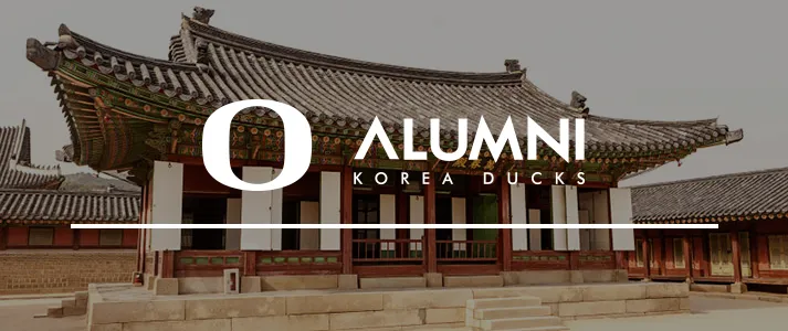 University of Oregon Alumni logo over temple in Korea