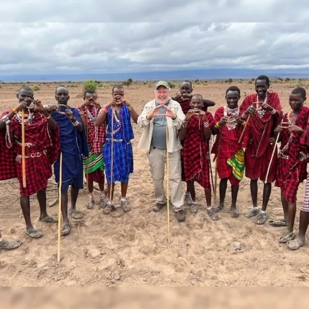 Robert with a large group of members of the Maasai Tribe throwing their Oregon O