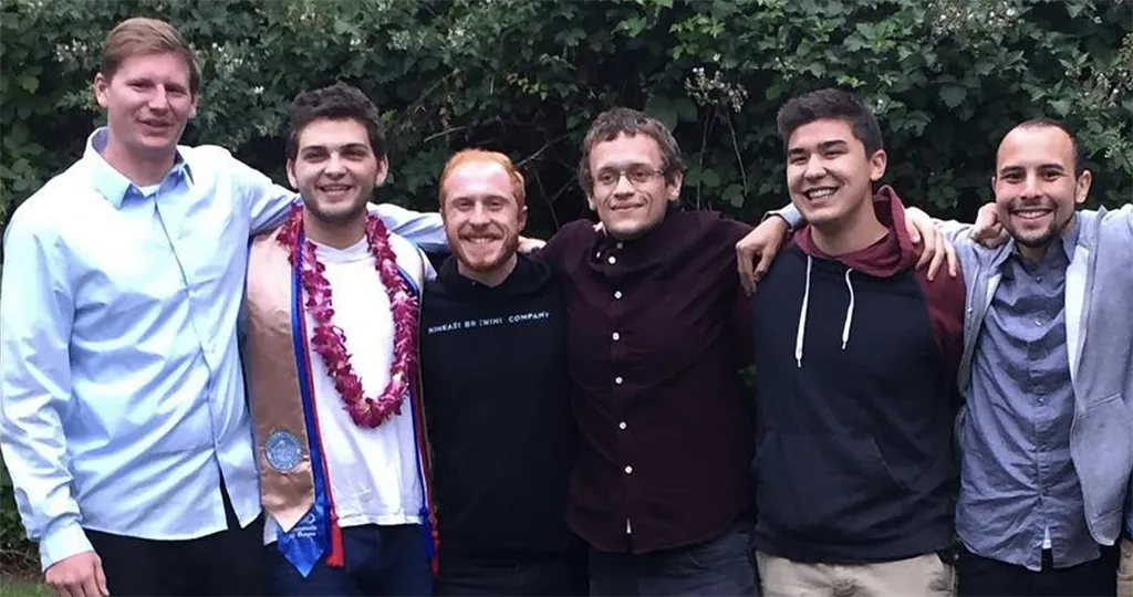 A group of men posing with each other for a picture. 