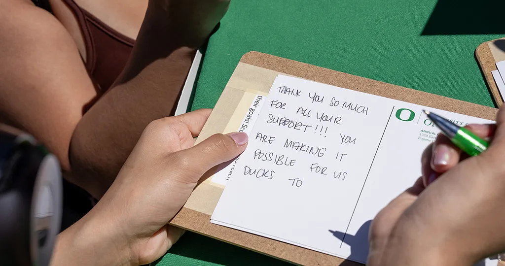 A person holding a thank you note for all the support they have received.