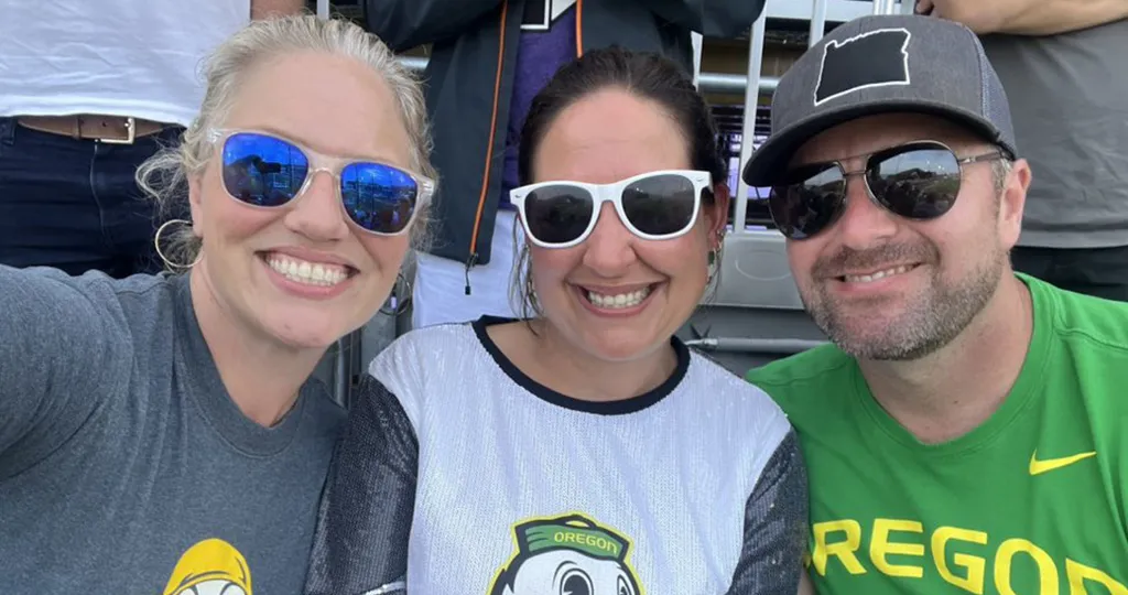 Kristen Vogt Veggeberg and her friends smile in a selfie wearing Duck gear.