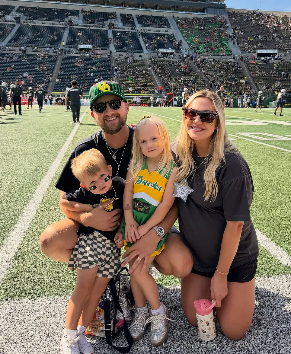 Marcus Harvey, his wife Noelle, and their two kids pose at Ducks Game at Autzen Stadium.