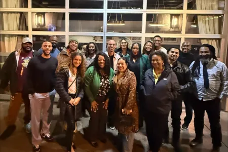The UOBAN Board of Directors stand together for a group picture in business casual clothing for a group dinner.