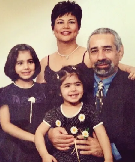 A family picture of a mother, father, and two daughters. 